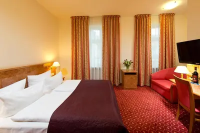 Ein Bett oder Betten in einem Zimmer der Unterkunft Hotel & Apartments Zarenhof Berlin Prenzlauer Berg