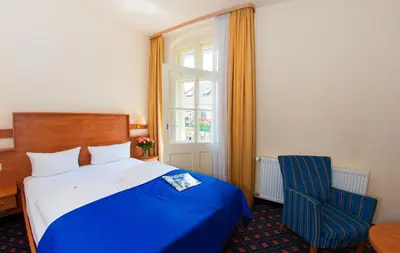 Ein Bett oder Betten in einem Zimmer der Unterkunft Hotel & Apartments Zarenhof Berlin Prenzlauer Berg