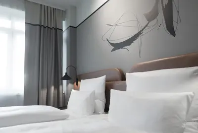 Ein Bett oder Betten in einem Zimmer der Unterkunft TITANIC Comfort Kurfürstendamm