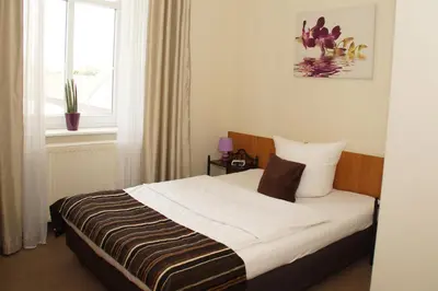 Ein Bett oder Betten in einem Zimmer der Unterkunft Gut Hotel Stadt Beelitz