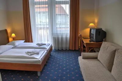 Ein Bett oder Betten in einem Zimmer der Unterkunft Hotel Europa City