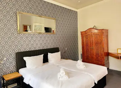 Ein Bett oder Betten in einem Zimmer der Unterkunft Pension Am Park