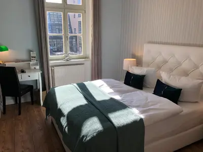 Ein Bett oder Betten in einem Zimmer der Unterkunft THE GATE GARDEN Hotel