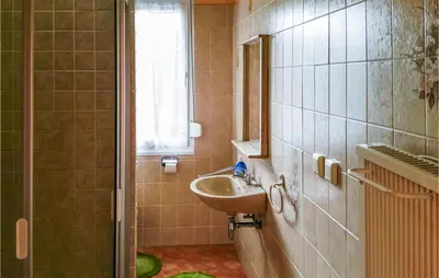 Ein Badezimmer in der Unterkunft Ferienhaus E.-Th�lmann-Str. H