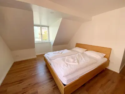 Ein Bett oder Betten in einem Zimmer der Unterkunft Colonial Café Pension