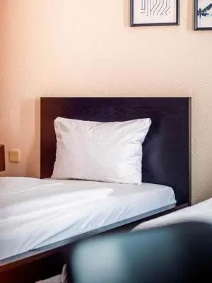 Ein Bett oder Betten in einem Zimmer der Unterkunft Hotel Berliner Bär