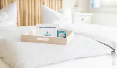 Ein Bett oder Betten in einem Zimmer der Unterkunft Pension zur Regatta