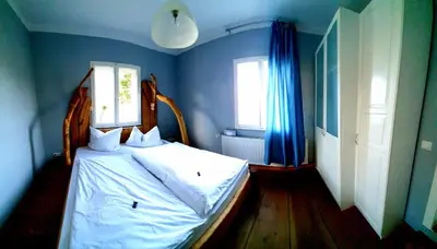 Ein Bett oder Betten in einem Zimmer der Unterkunft Alexandrowka Wohnen im UNESCO Weltkulturerbe Haus