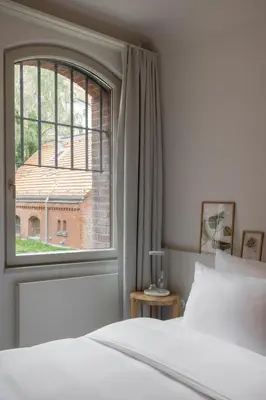 Ein Bett oder Betten in einem Zimmer der Unterkunft Wilmina Hotel