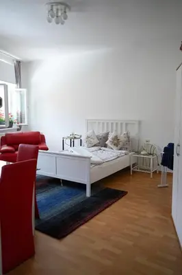 Ein Bett oder Betten in einem Zimmer der Unterkunft Cafe Alice & Pension GmbH
