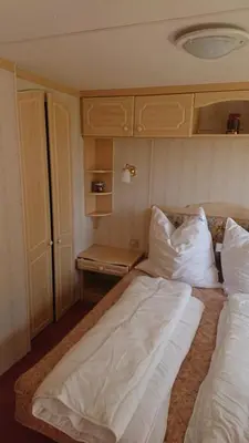 Ein Bett oder Betten in einem Zimmer der Unterkunft Mobilheim Monika