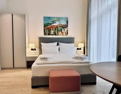 Ein Bett oder Betten in einem Zimmer der Unterkunft Elisapart - Apartments am Sommerschloss