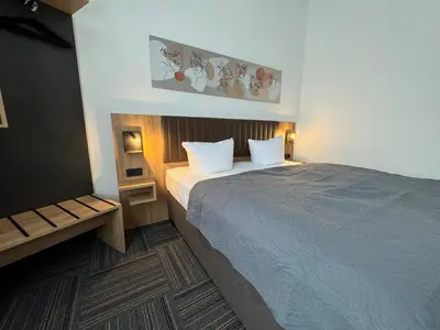 Ein Bett oder Betten in einem Zimmer der Unterkunft Hotel Bregenz