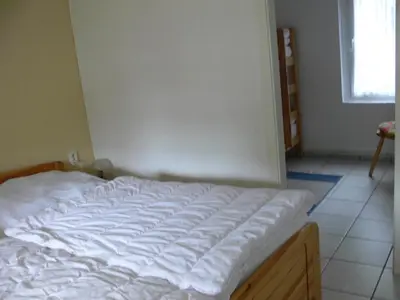 Ein Bett oder Betten in einem Zimmer der Unterkunft Ferienhäuser Heideröslein