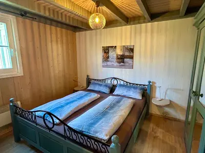 Ein Bett oder Betten in einem Zimmer der Unterkunft Ferienhaus mit Wasserterrasse - mit Sauna und Kamin - inklusive Nebenkosten
