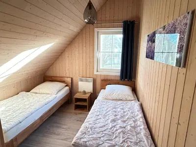 Ein Bett oder Betten in einem Zimmer der Unterkunft Ferienhaus mit Wasserterrasse - mit Sauna und Kamin - inklusive Nebenkosten