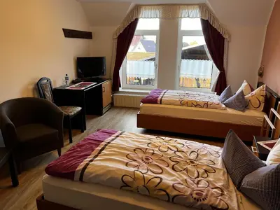 Ein Bett oder Betten in einem Zimmer der Unterkunft Pension Zur Mühle