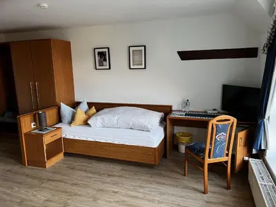 Ein Bett oder Betten in einem Zimmer der Unterkunft Pension Zur Mühle