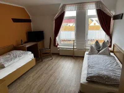 Ein Bett oder Betten in einem Zimmer der Unterkunft Pension Zur Mühle