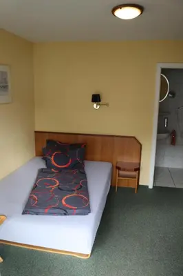 Ein Bett oder Betten in einem Zimmer der Unterkunft Stadthotel Brandenburger Hof